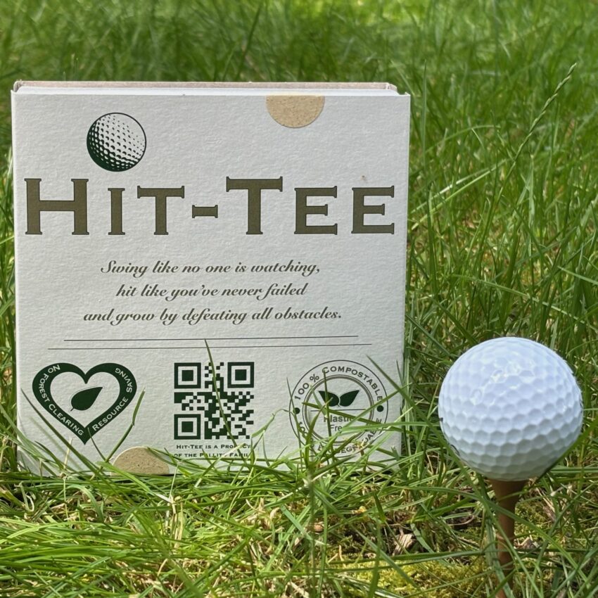 Hit-Tee in 100 pcs package in the grass beside a ball